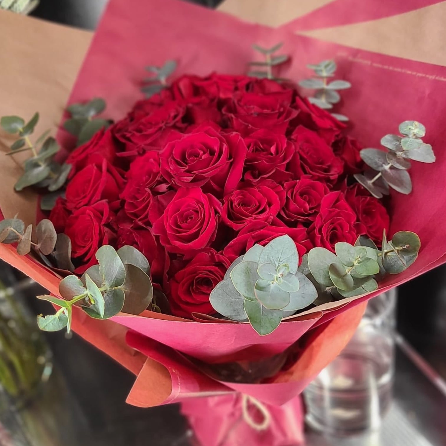 Classic spiral bouquet of red roses with eucalptus.